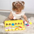 Little girl playing with Montessori Geometric Eggs.