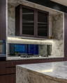 Havit LED strip lighting beneath marble kitchen cabinetry.