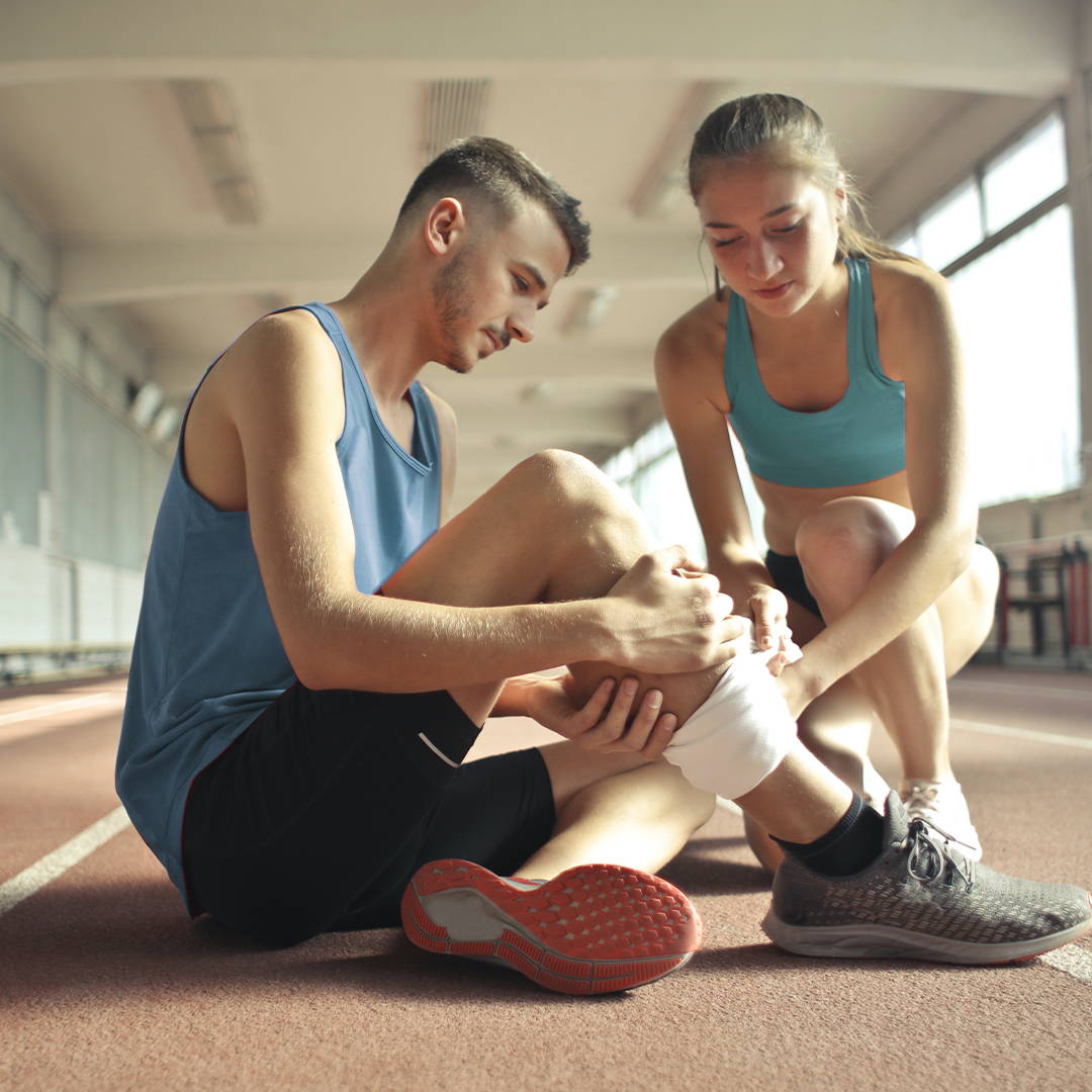 women helping man with sore shins