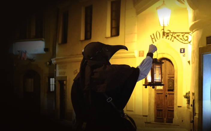 Plague doctor holding a lamp in the streets of Prague (preview)