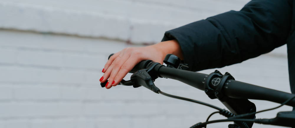 Close up of handes on handlebars of electric city bike
