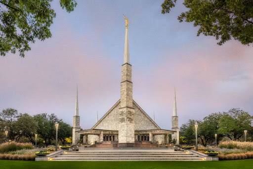 Photo of the LDS Dallas Temple against a blue and pink sky. 