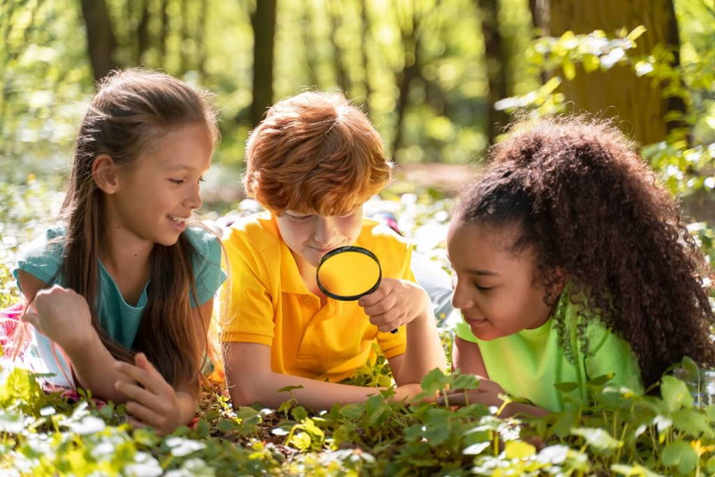 Group of kids playing scavenger hunt in the woods.