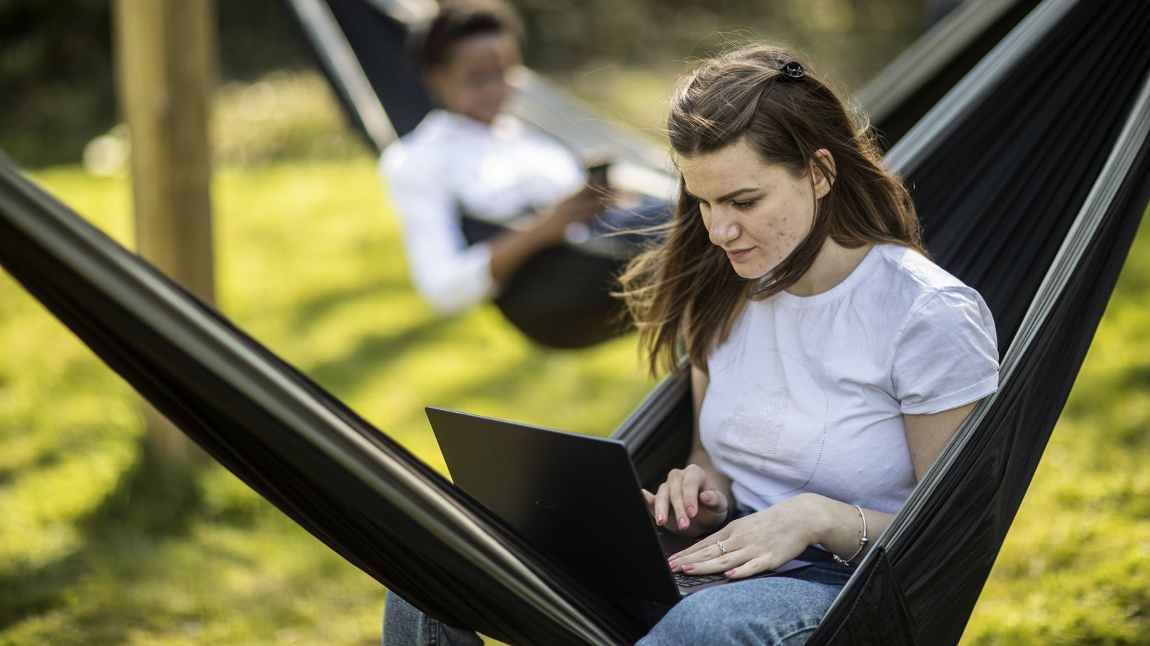 Student in a hammock with a laptop