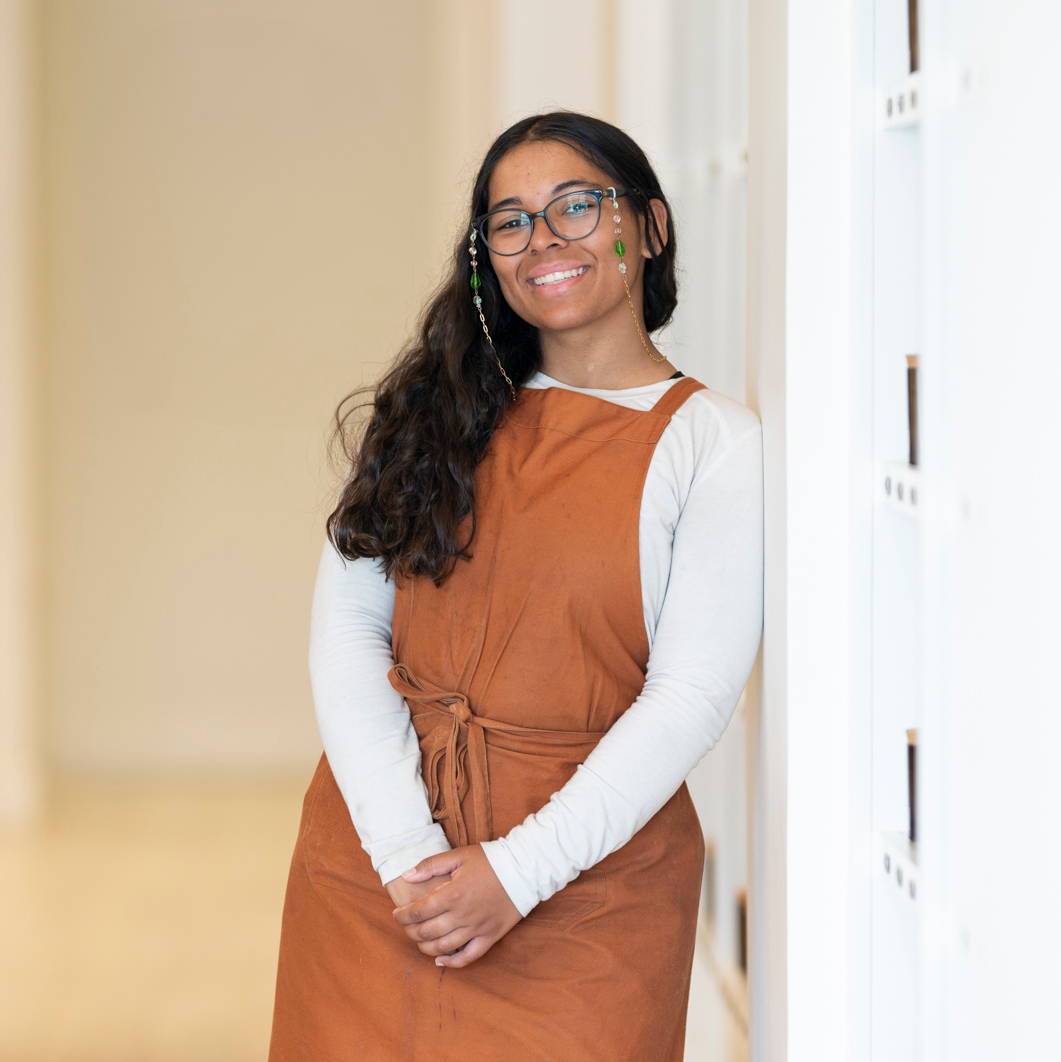 girl in orange apron smiling