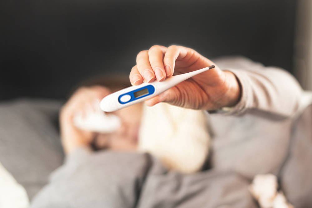 Woman holding a thermometer