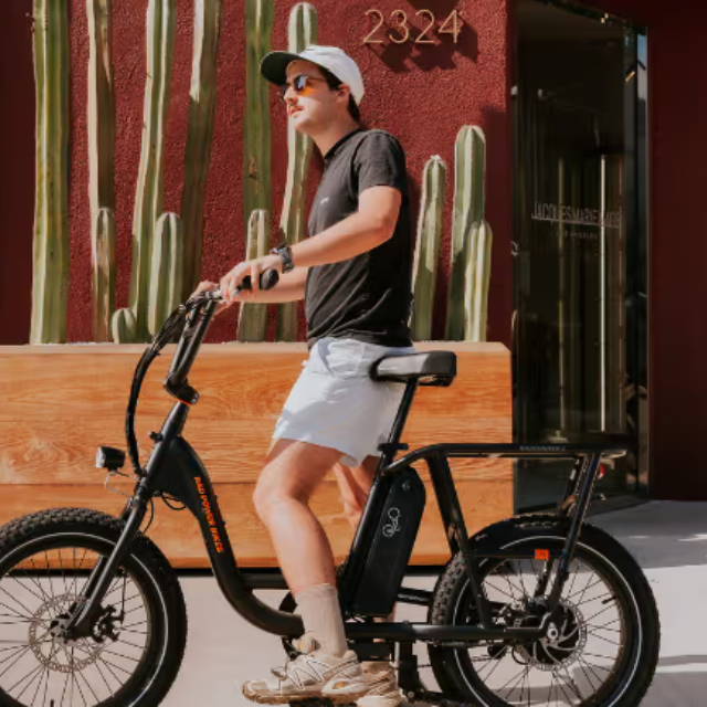 Rider on RadRunner electric bike on sidewalk
