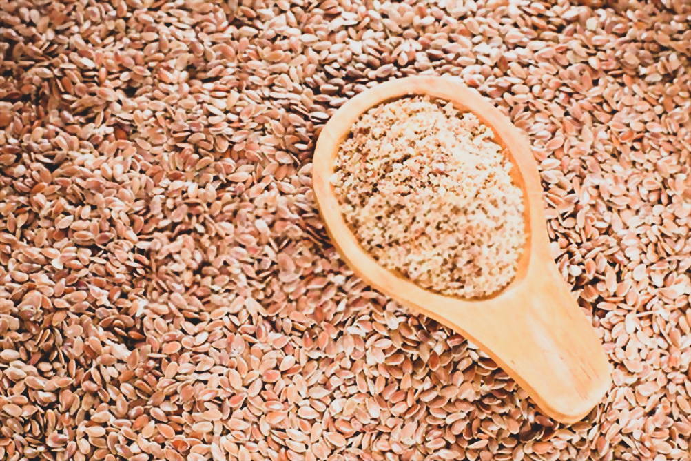 Ground flax seeds with wooden spoon