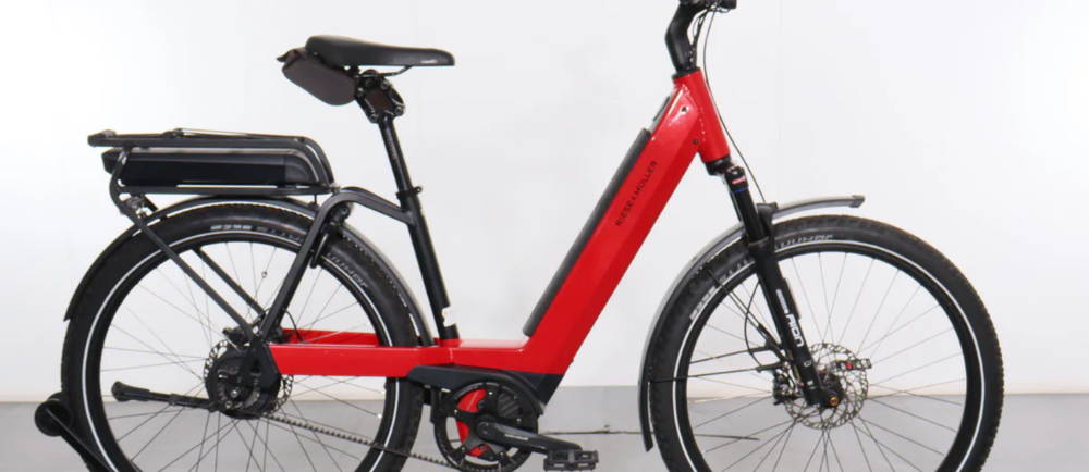 a red Riese & Müller Nevo GT Vario step through electric city bike
