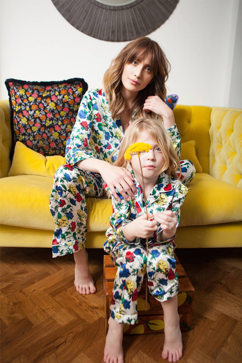 Luna and Tara Griffin sat on yellow sofa in in YOLKE Dakota Meadow Classic Silk Pyjama Set Meadow