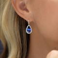 Pear-shaped sapphire earrings in woman's ear