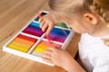Little girl sorting colors. 
