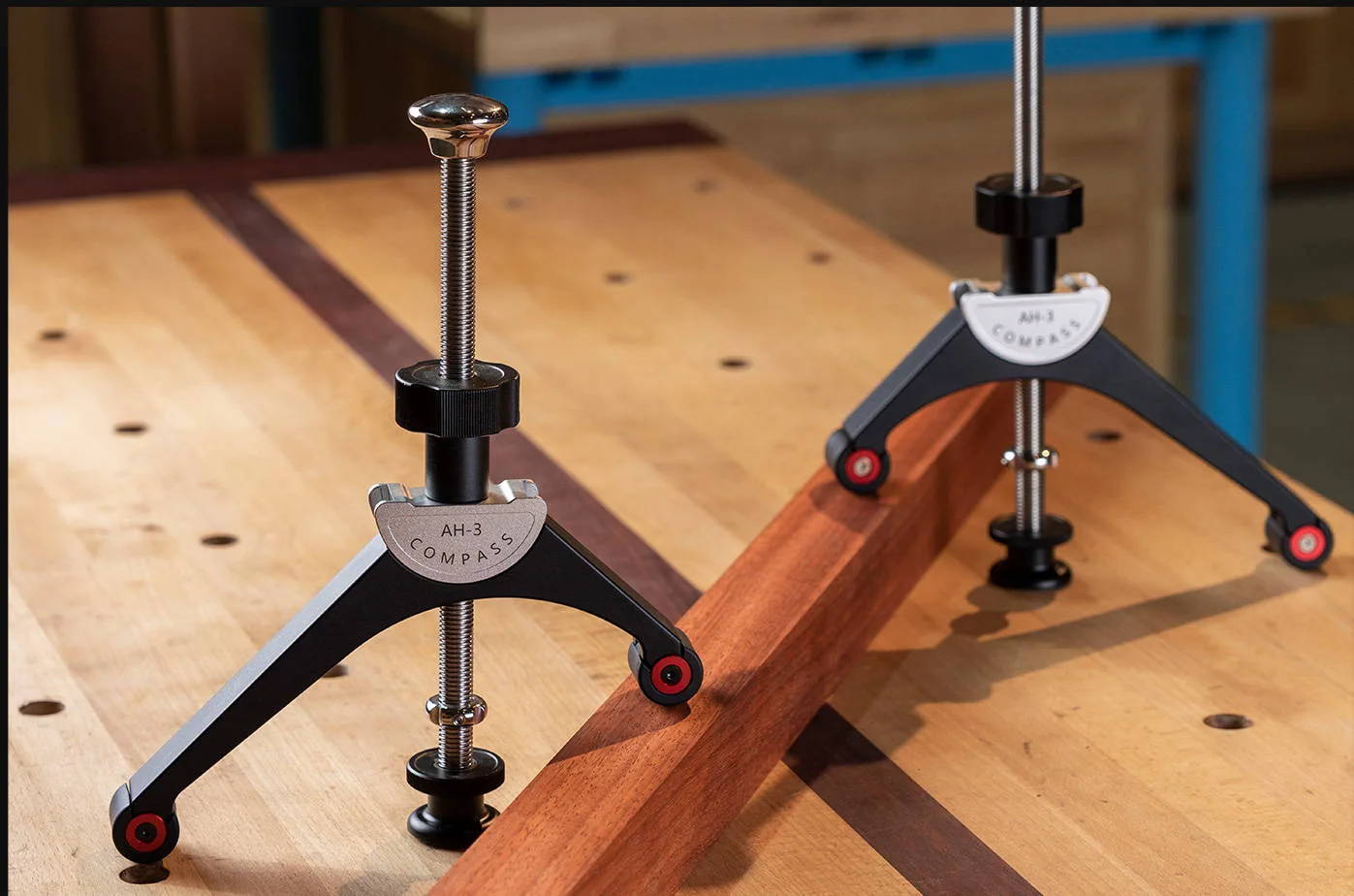 The Harvey Compass AH 3 Arch Hold Down demonstrates being used, holding down the long wooden plank in place