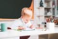 Little boy studying on his desk.