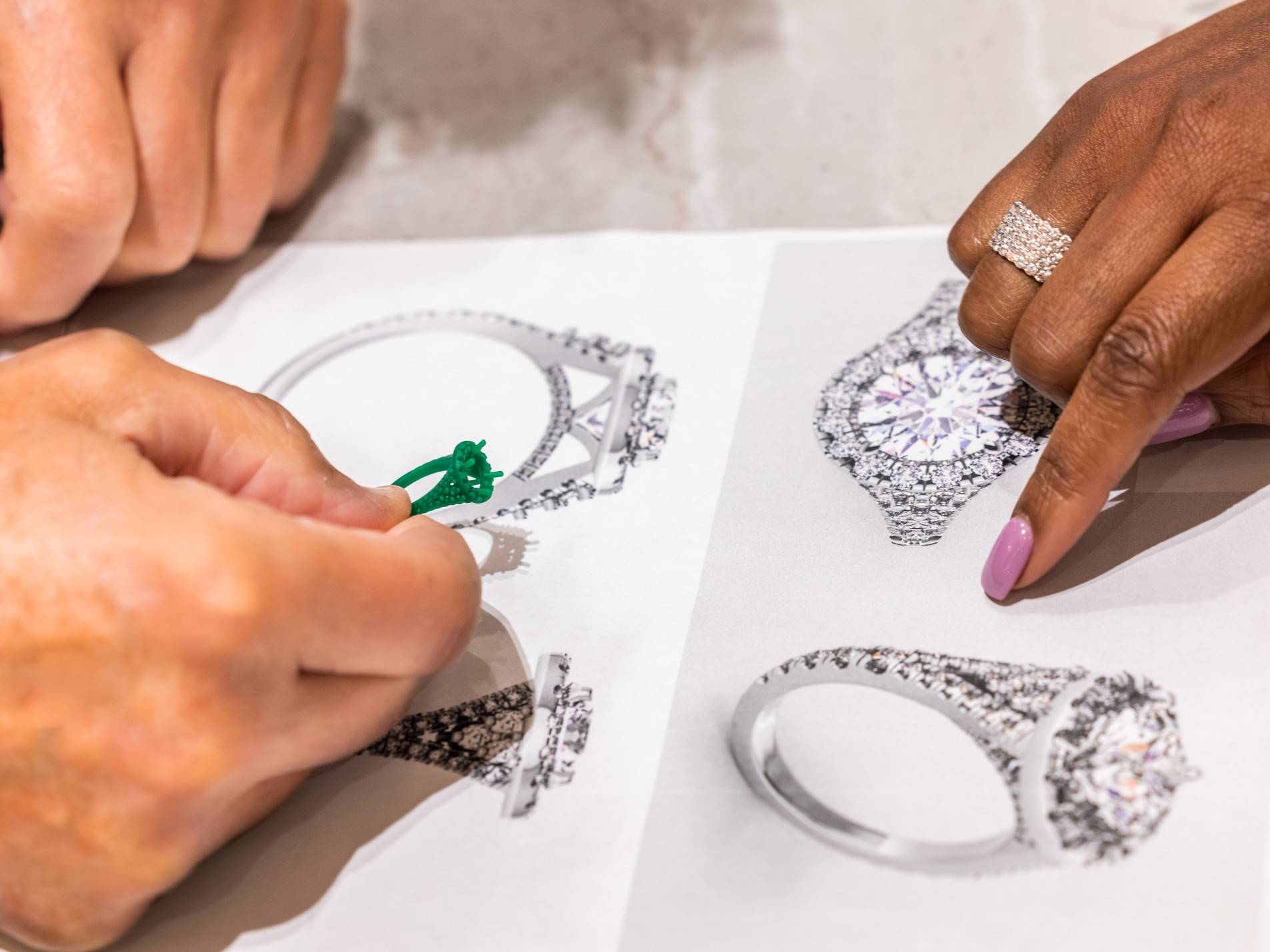 Gerry Turner and Nicole Williams looking at the engagement ring rendering.