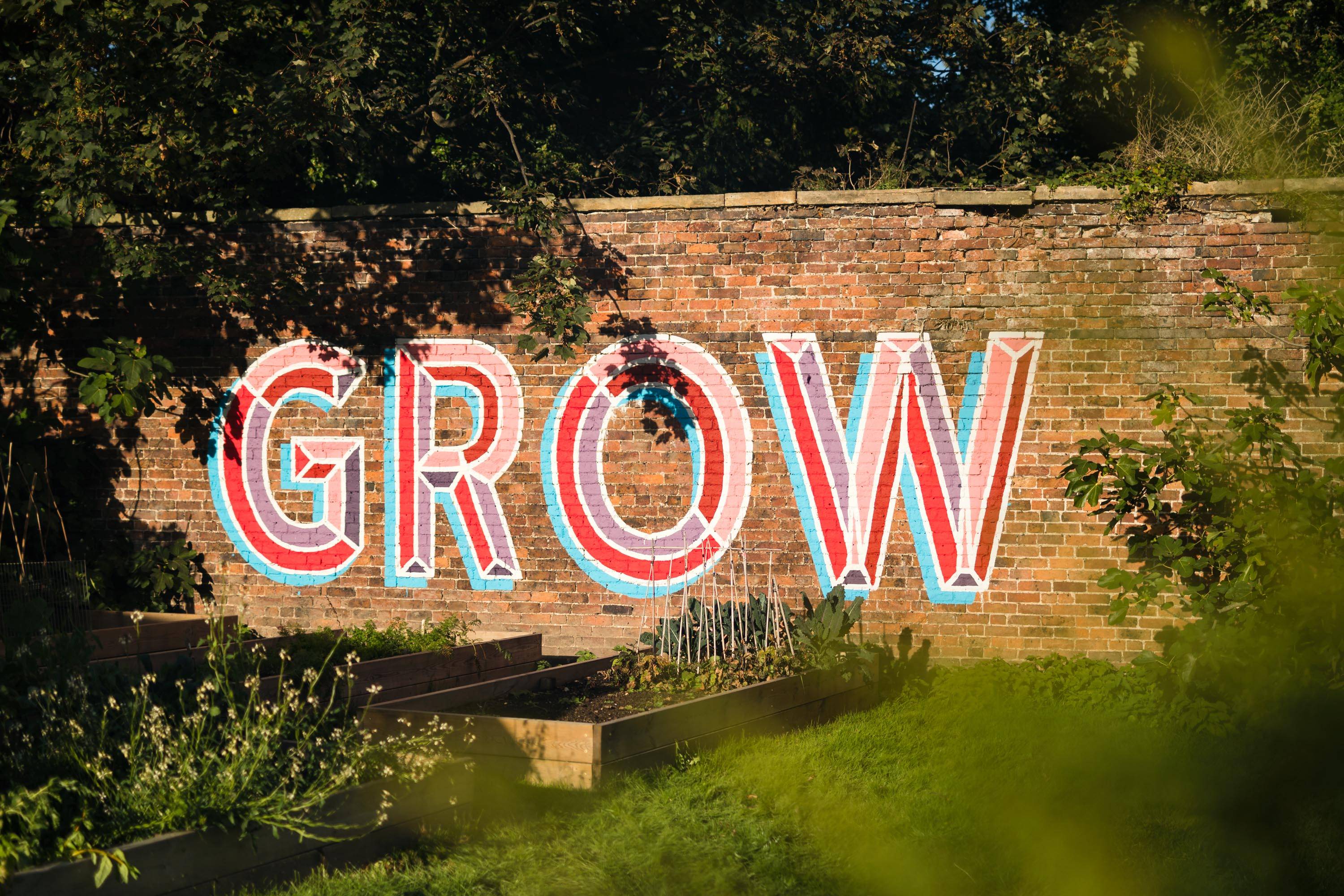 GROW art on veg garden wall at Hawarden Estate