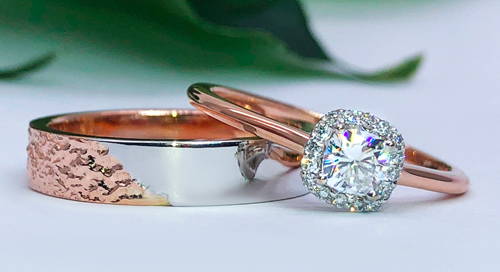 band wedding ring and engagement ring in rose gold with diamonds set on top of each other