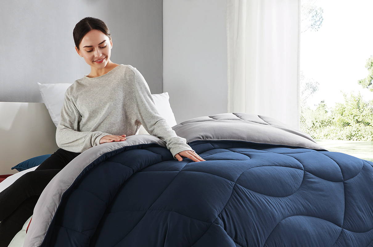 sleep zone bedding website store products collection all season reversible comforter navy blue grey gray woman on bed