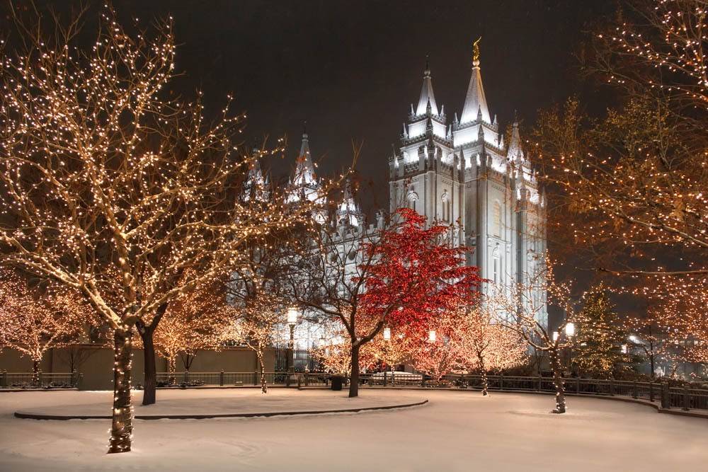 Salt Lake Temple grounds illuminated by Christmas lights.