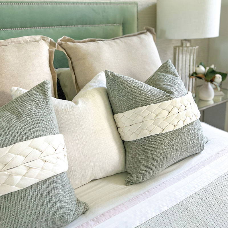 Sage green cushion covers with cream plaited luxe sashes to create a beautiful classic style bedroom