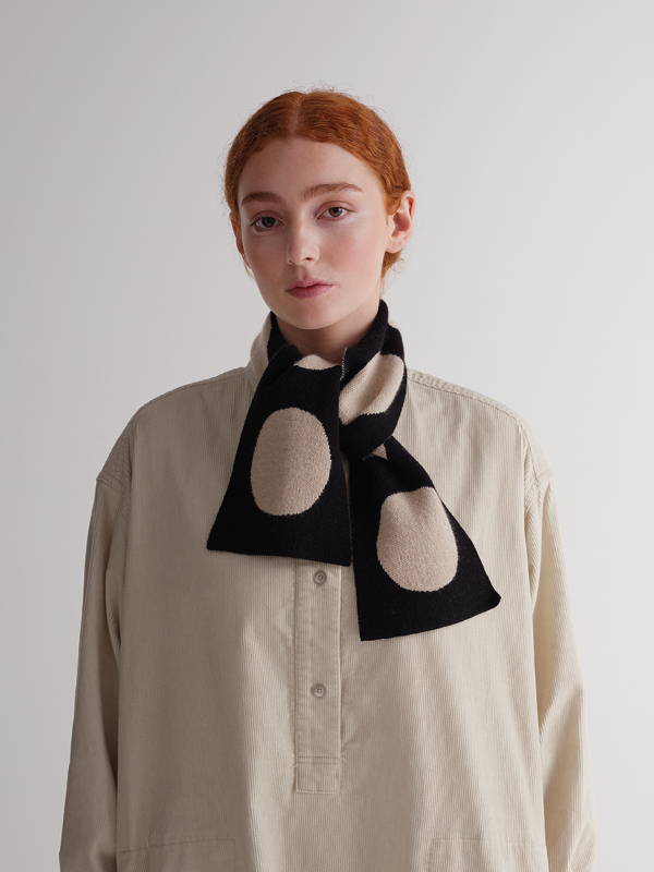 model wears small spot scarf black