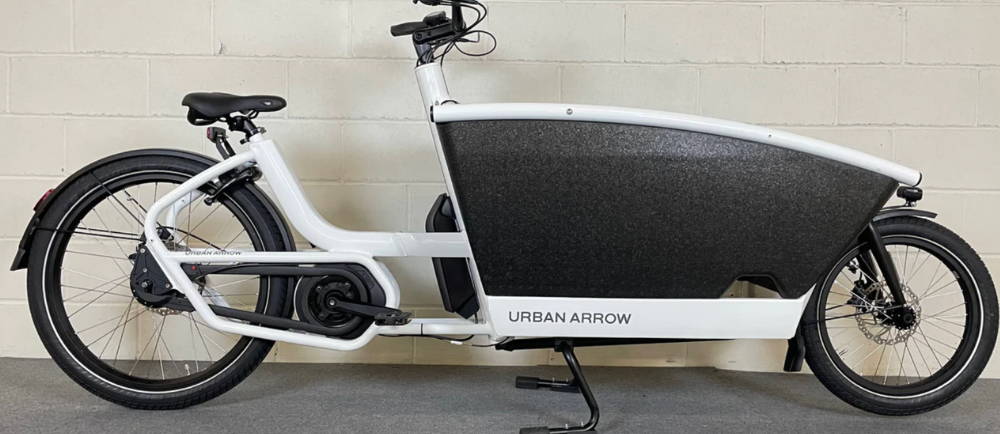A white Urban Arrow Family front-loader electric cargo bike
