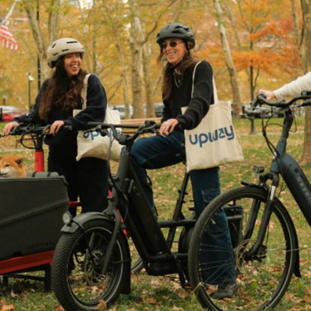 three women riding electic bikes in a park
