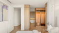 Havit LED strip and downlights in a master bedroom, illuminating timber joinery, a walk-in wardrobe and freestanding bath beyond.