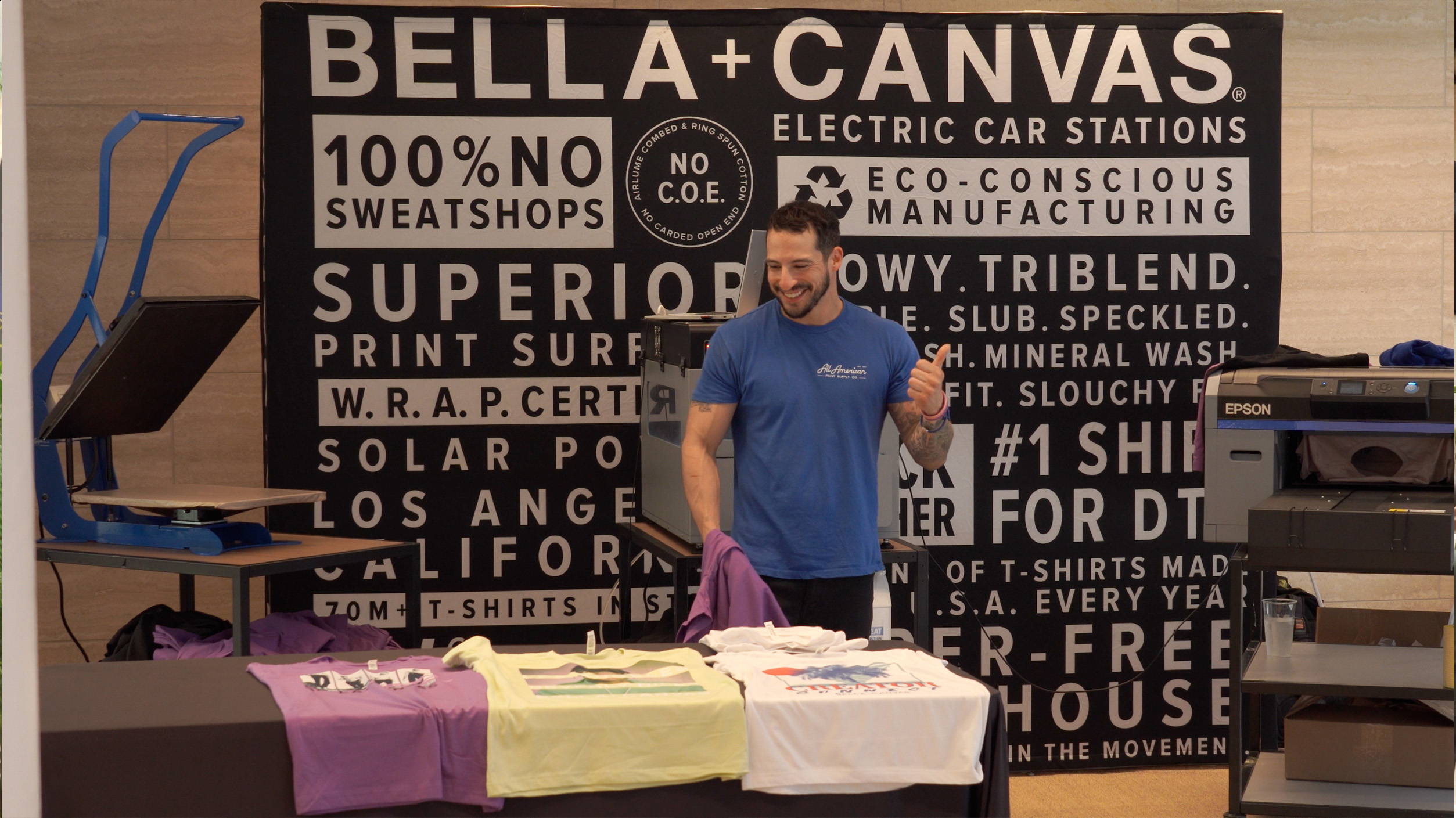 All American Print Supply Co's Estevan Romero demonstrating DTG printing process on the Epson F2100 printer at the BELLA+CANVAS Creator Connect 2022 event. 