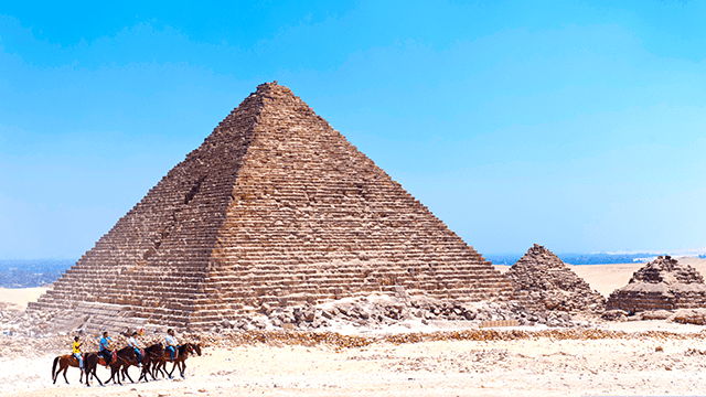 Riding horses at Menkaure's Great Pyramid at Giza, Egypt
