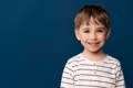 Preschooler boy smiling at the camera.