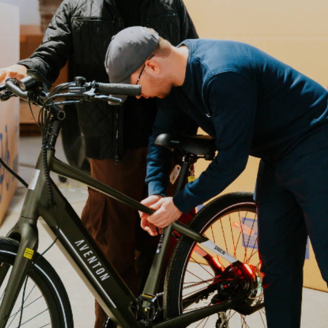A a bke technician inspecting an Aventon e-bike