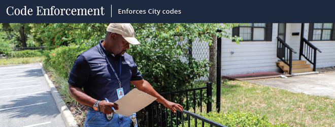 a dude inspects a nasty looking fence that has something suspicious smeared on it