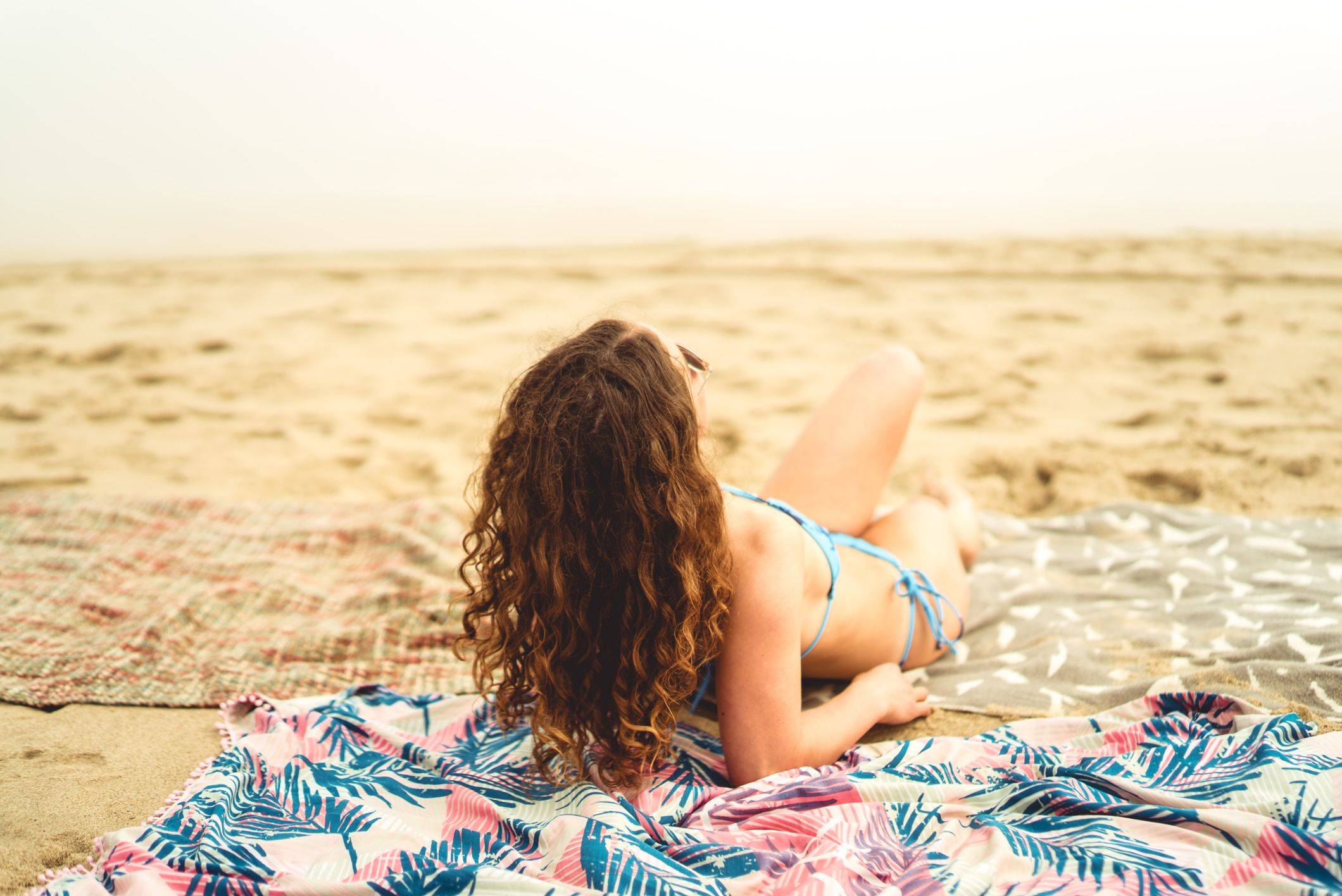 Image of georgie lying on beach