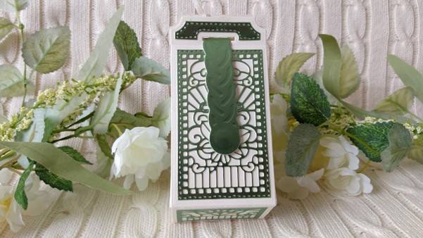 a green and white box with a handle
