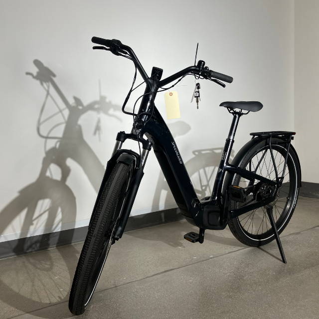 a specialized electric bike against a white wall