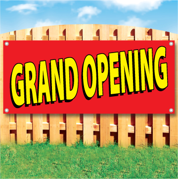 Wood fence displaying a banner saying 'GRAND OPENING' in yellow text on a red background
