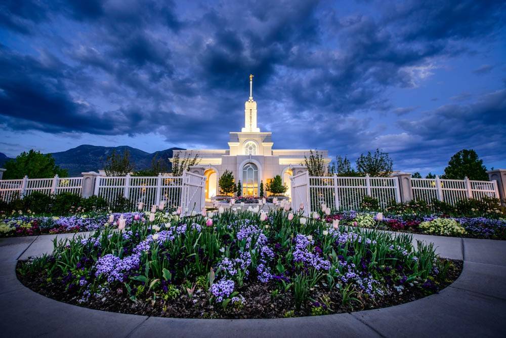 LDS art photo of the Mt Timpanogos Temple behind a large, circular flower bed.