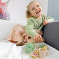 Little girl playing with a Montessori Tea Set. 