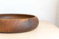 shallow brown wooden fruit bowl rim