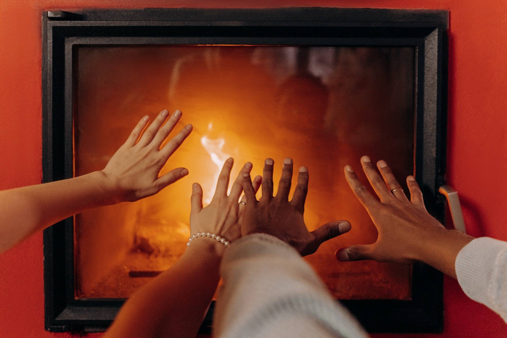 Hands in front of fireplace