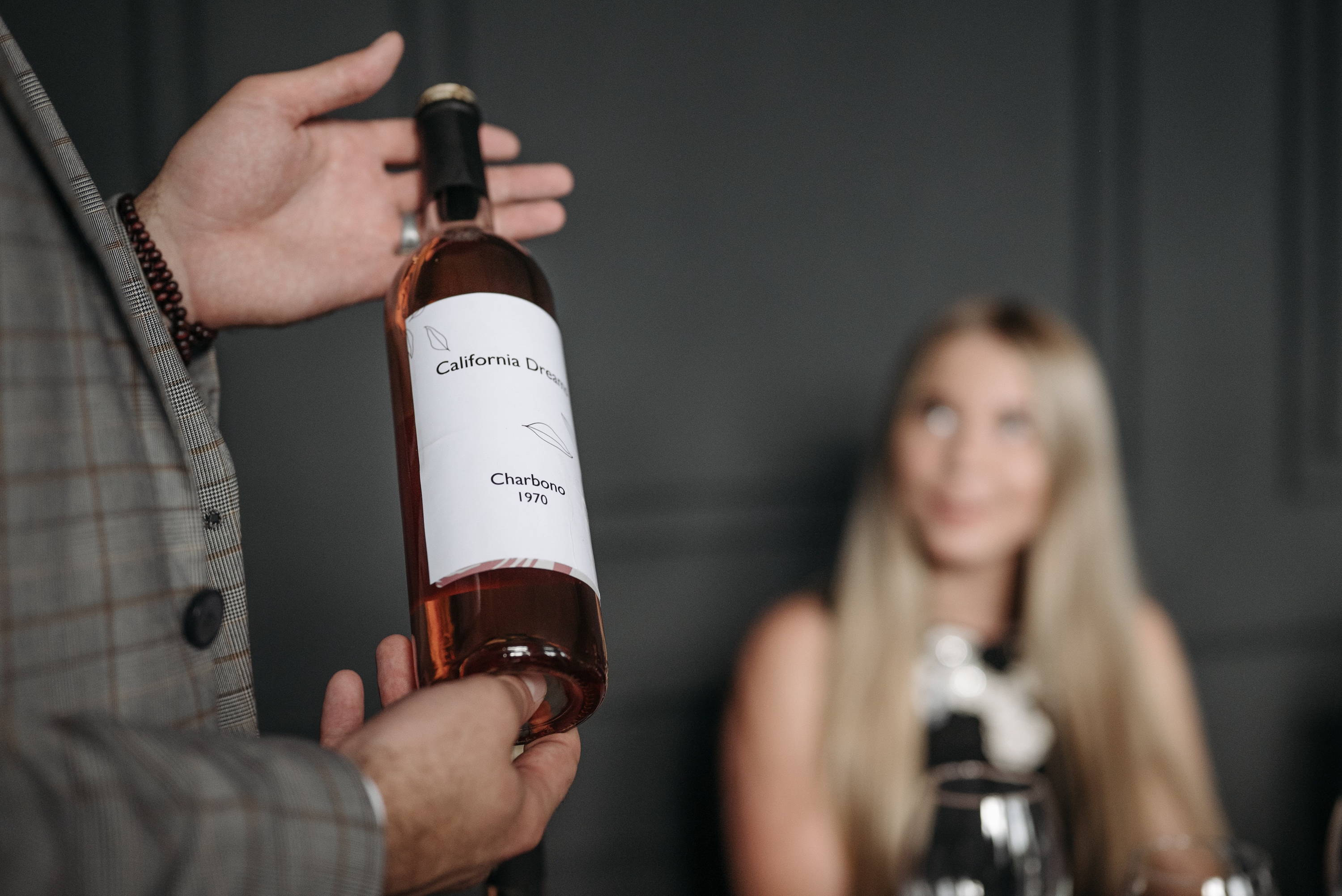 Lady at restaurant asking the sommelier about best wine types on the menu.