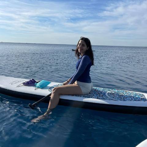 Girl stand up paddle board inflatable and smile