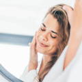 woman touching her face using glycolic acid