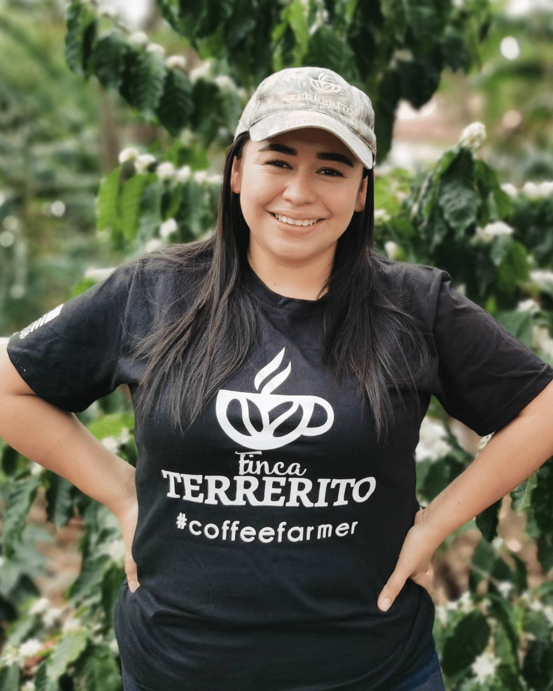 Woman standing beside coffee tree