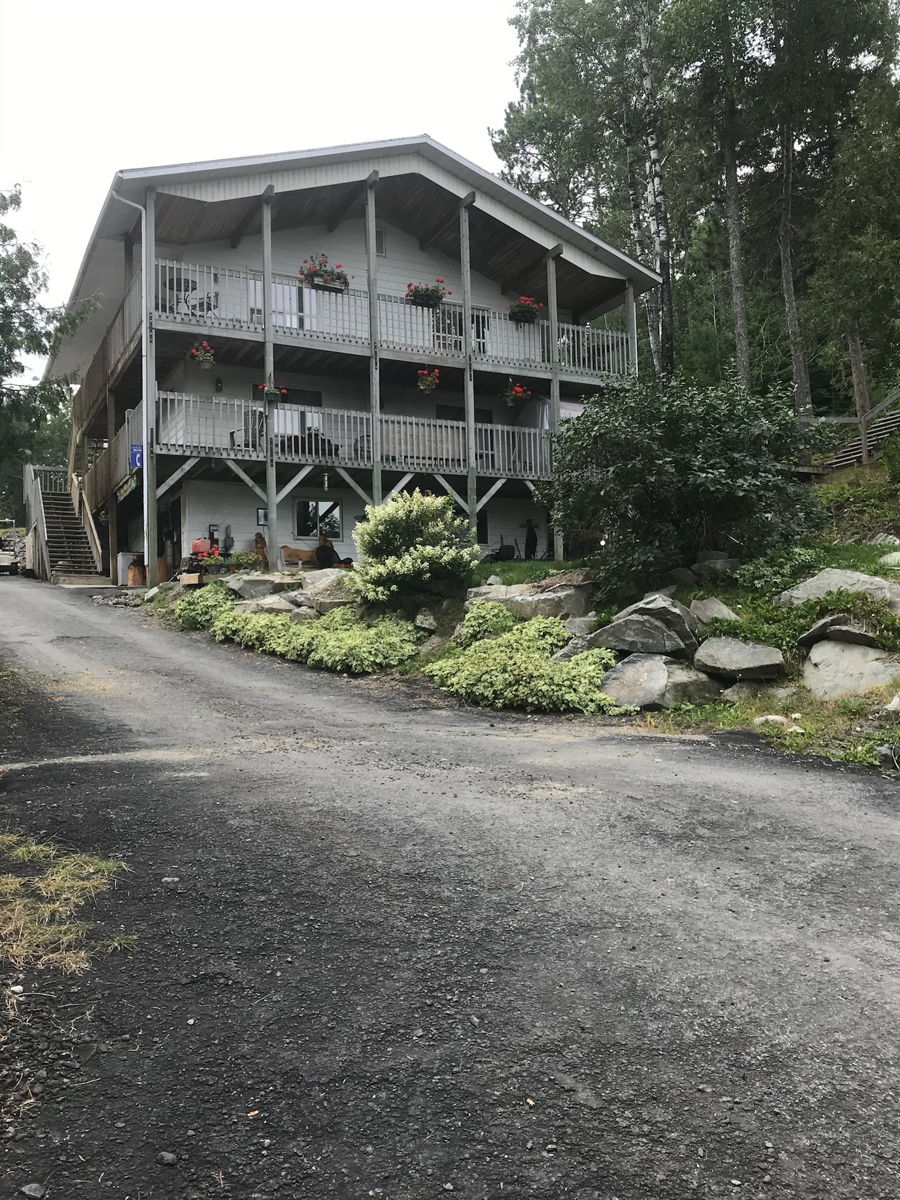 Two-story lodge with covered porches at Muskie Bay Resort
