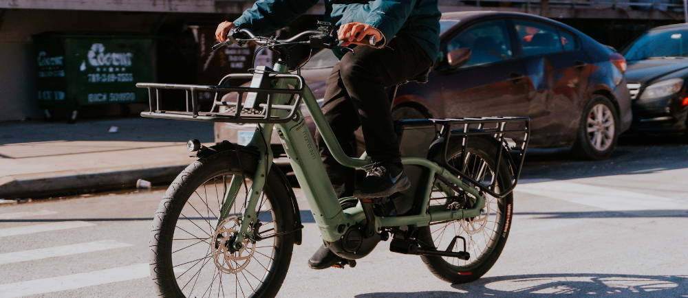 Rider on Momentum PakYak+ cargo electric bike