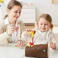 Mother and daughter smiling while playing with Montessori Woodpecker in daughter's room. 