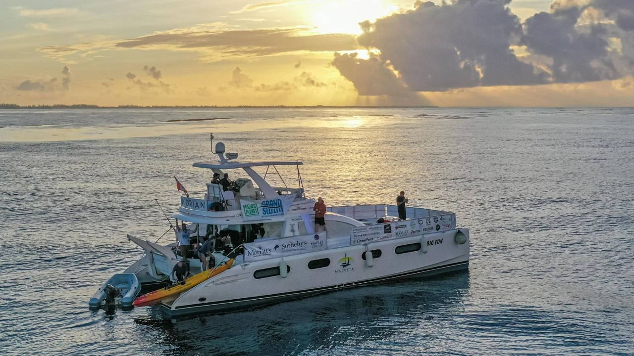 The boat and crew of The Grand Swim in Grand Caymansailing in the ocean