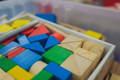 Multicolor wooden blocks placed tidily in a storage tray. 